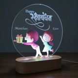 Shayona Gift Shop-Personalized Rakshabandhan Brother Sister Acrylic LED Night Light – Custom Engraved Name Lamp with Cute Brother Giving Gift Illustration & Wooden Base, Rakhi Gift for Sister & Brother