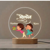 Shayona Gift Shop-Personalized Rakshabandhan Brother Sister Acrylic LED Night Light – Custom Engraved Name Lamp with Cute Brother Giving Gift Illustration & Wooden Base, Rakhi Gift for Sister & Brother